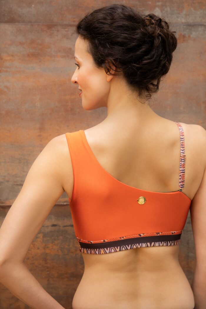 Women's back with an orange bikini top